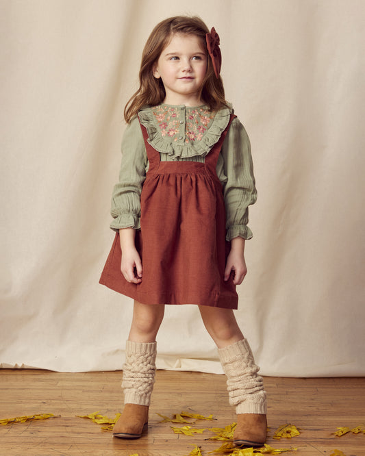 Early Sunday, Annie Skirt in Caramel, made from Cotton Corduroy fabric, featuring a relaxed fit with an elastic waistband & beautiful embroidery, shown in a front view of model wearing it