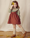 Early Sunday, Annie Skirt in Caramel, made from Cotton Corduroy fabric, featuring a relaxed fit with an elastic waistband & beautiful embroidery, shown in a front view of model wearing it
