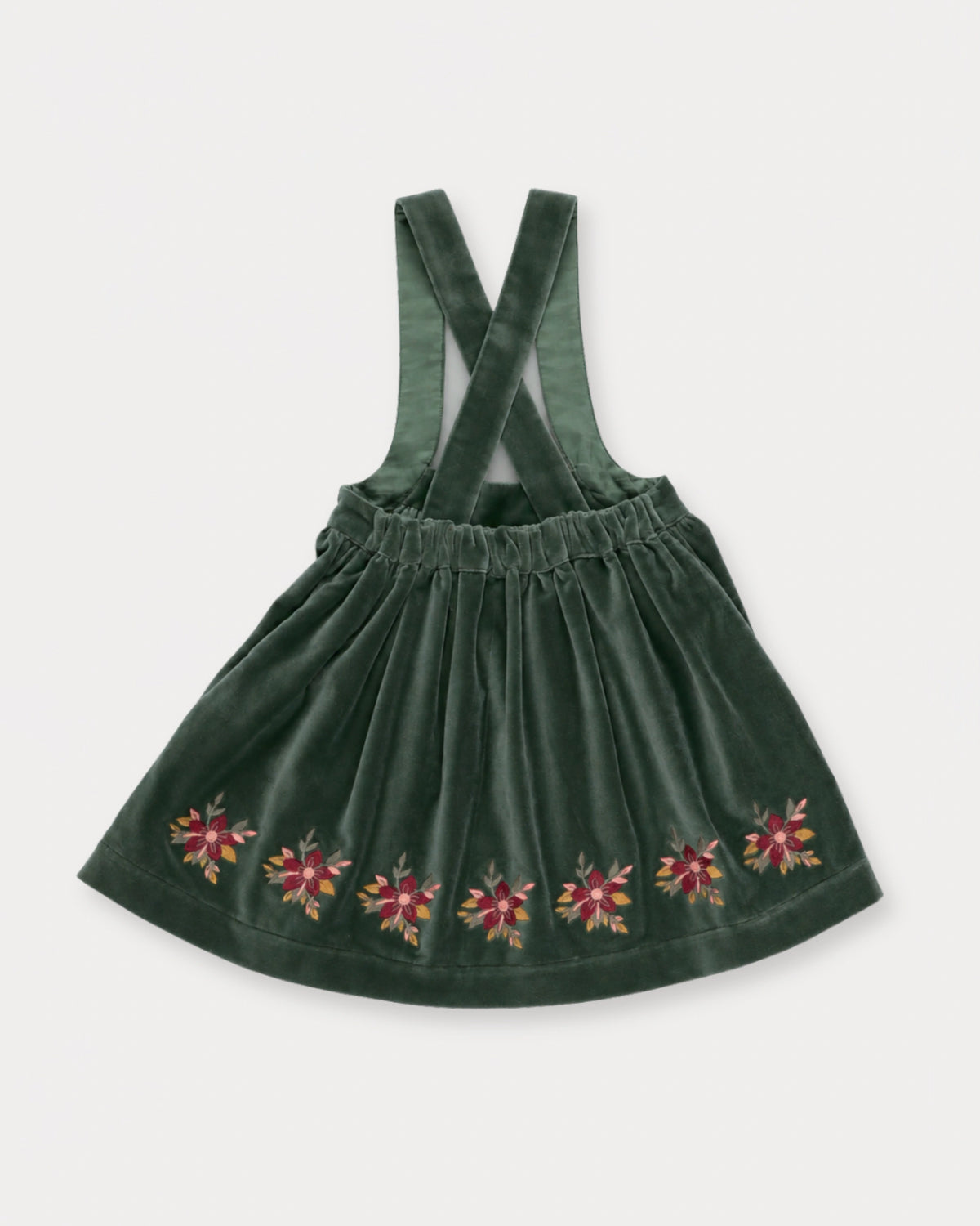 Early Sunday, Annie Skirt in Forest Green, made from Cotton Velvet Velour's fabric, featuring an A-line silhouette with adjustable cross-back straps and soft gathers, shown in a back flat-lay view