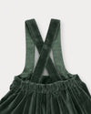 Early Sunday, Annie Skirt in Forest Green, made from Cotton Velvet Velour's fabric, featuring an A-line silhouette with adjustable cross-back straps and soft gathers, shown in a closeup flat-lay view