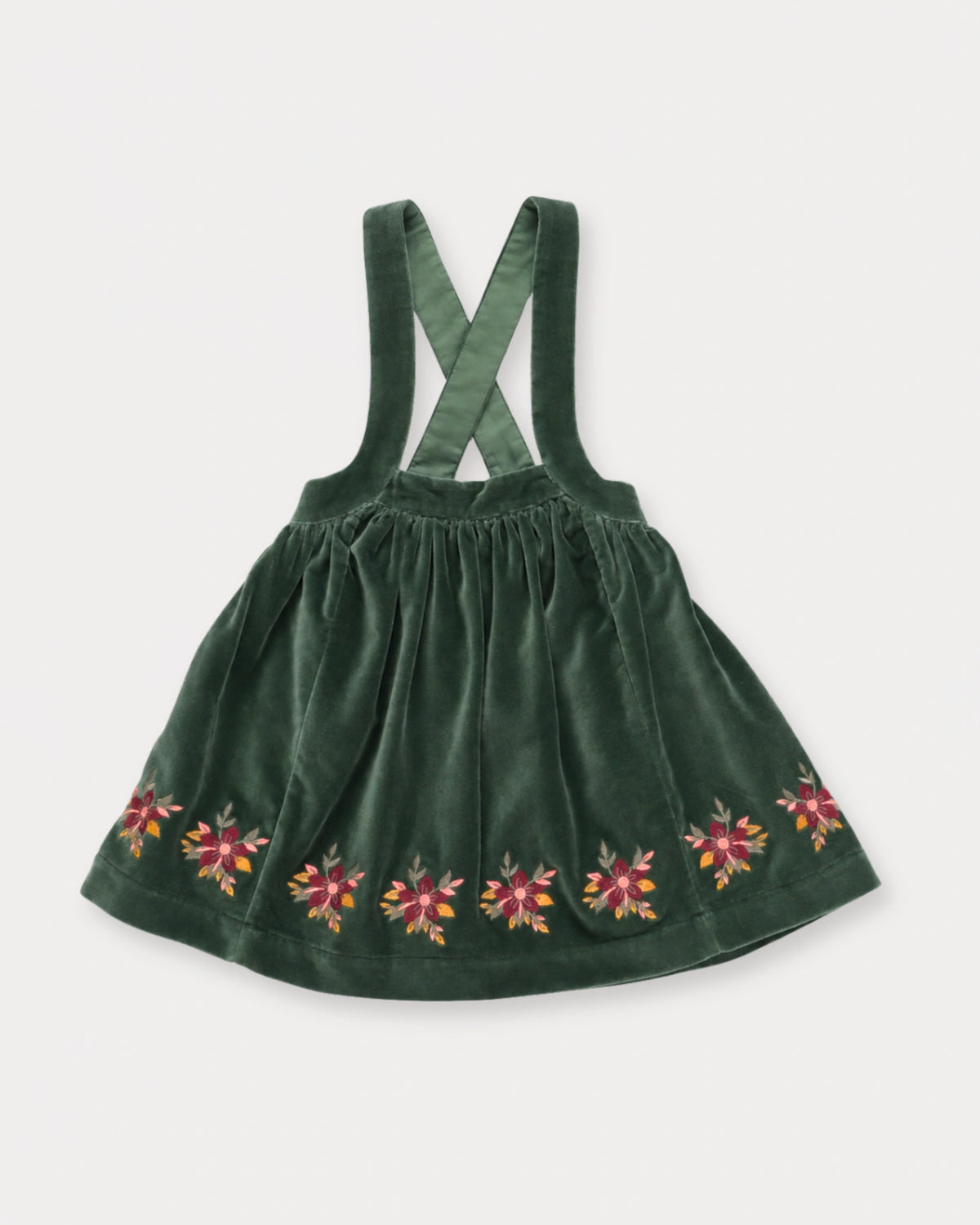 Early Sunday, Annie Skirt in Forest Green, made from Cotton Velvet Velour's fabric, featuring an A-line silhouette with adjustable cross-back straps and soft gathers, shown in a front flat-lay view