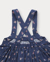 Early Sunday, Annie Skirt in Ditsy Bouquet Navy, made from Printed Cotton Satin fabric, featuring an A-line silhouette with adjustable cross-back straps and soft gathers, shown in a closeup flat-lay view