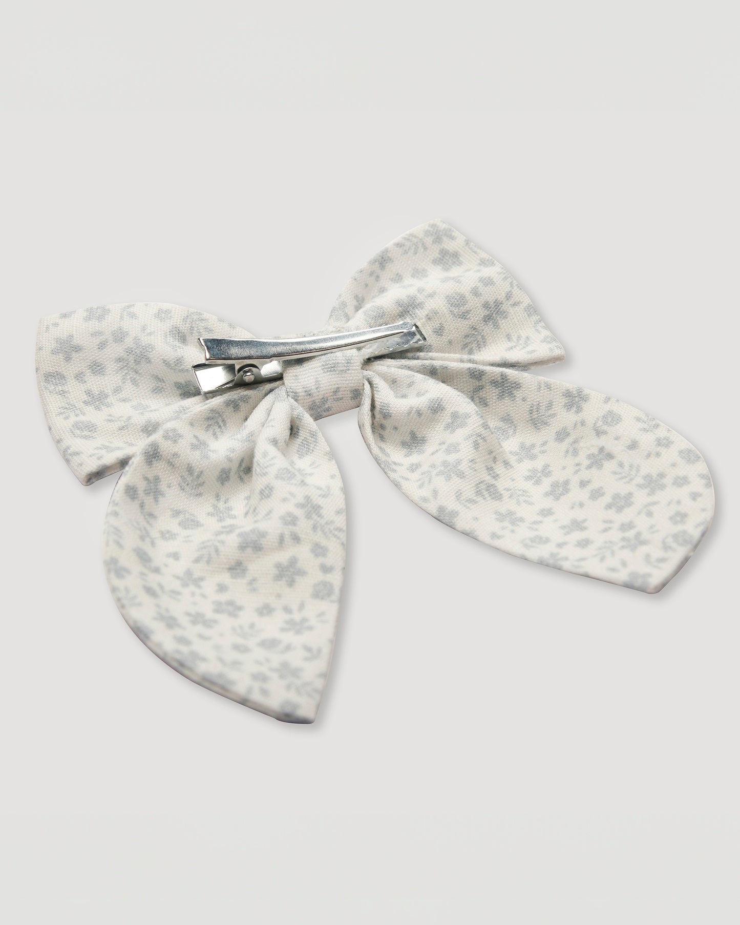 Early Sunday, Audrey Alligator Clip in Mini Flower print, made from Printed canvas 70% Cotton 30% Linen fabric, featuring a fabric bow design with a secure hair clip fastening, shown in a back flat-lay view