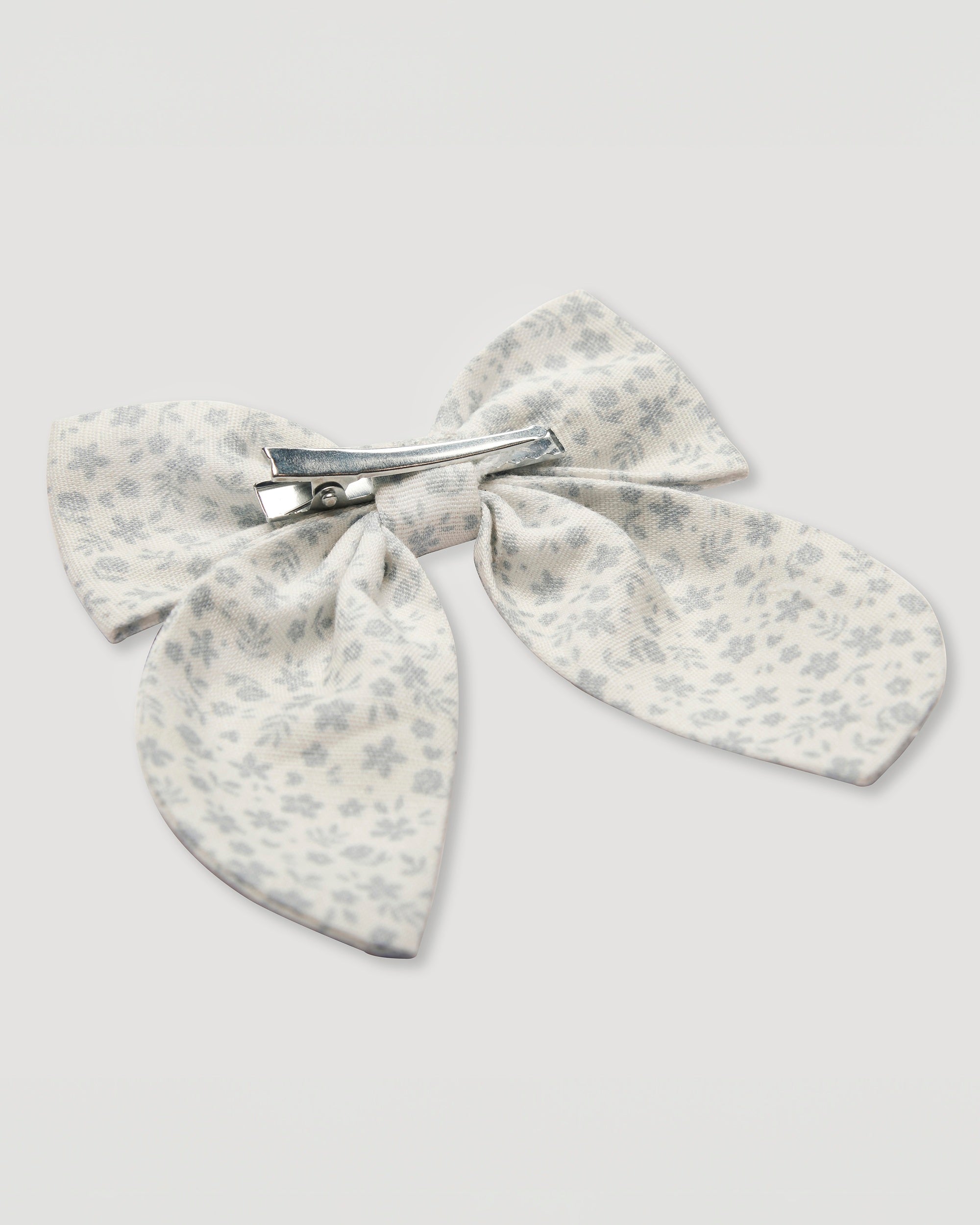 Early Sunday, Audrey Alligator Clip in Mini Flower print, made from Printed canvas 70% Cotton 30% Linen fabric, featuring a fabric bow design with a secure hair clip fastening, shown in a back flat-lay view