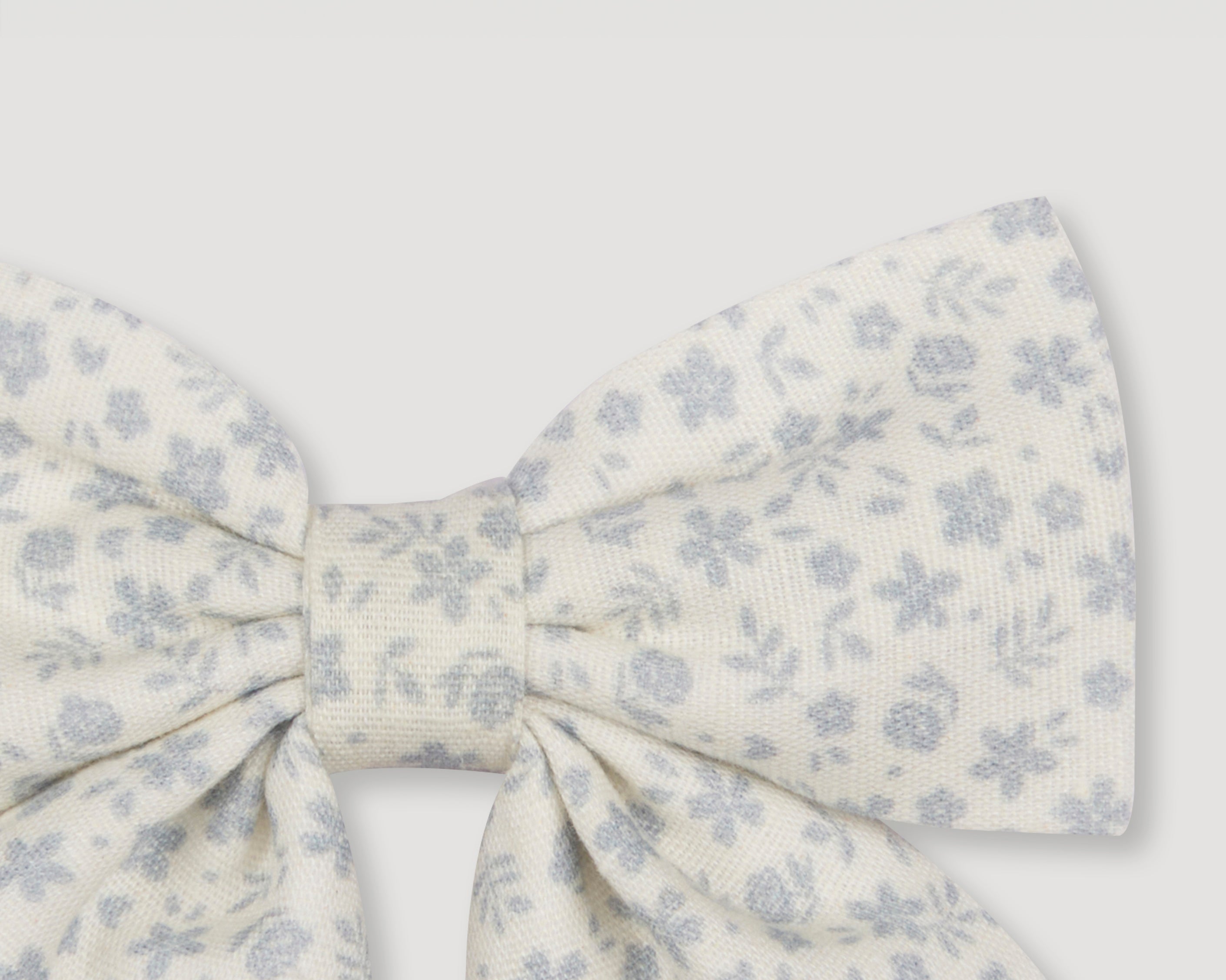 Early Sunday, Audrey Alligator Clip in Mini Flower print, made from Printed canvas 70% Cotton 30% Linen fabric, featuring a fabric bow design with a secure hair clip fastening, shown in a closeup flat-lay view