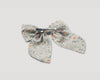 Early Sunday, Audrey Alligator Clip in Amelia print, made from Printed Cotton Cambric fabric, featuring a fabric bow design with a secure hair clip fastening, shown in a closeup flat-lay view
