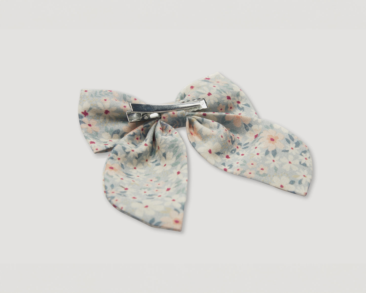 Early Sunday, Audrey Alligator Clip in Amelia print, made from Printed Cotton Cambric fabric, featuring a fabric bow design with a secure hair clip fastening, shown in a closeup flat-lay view