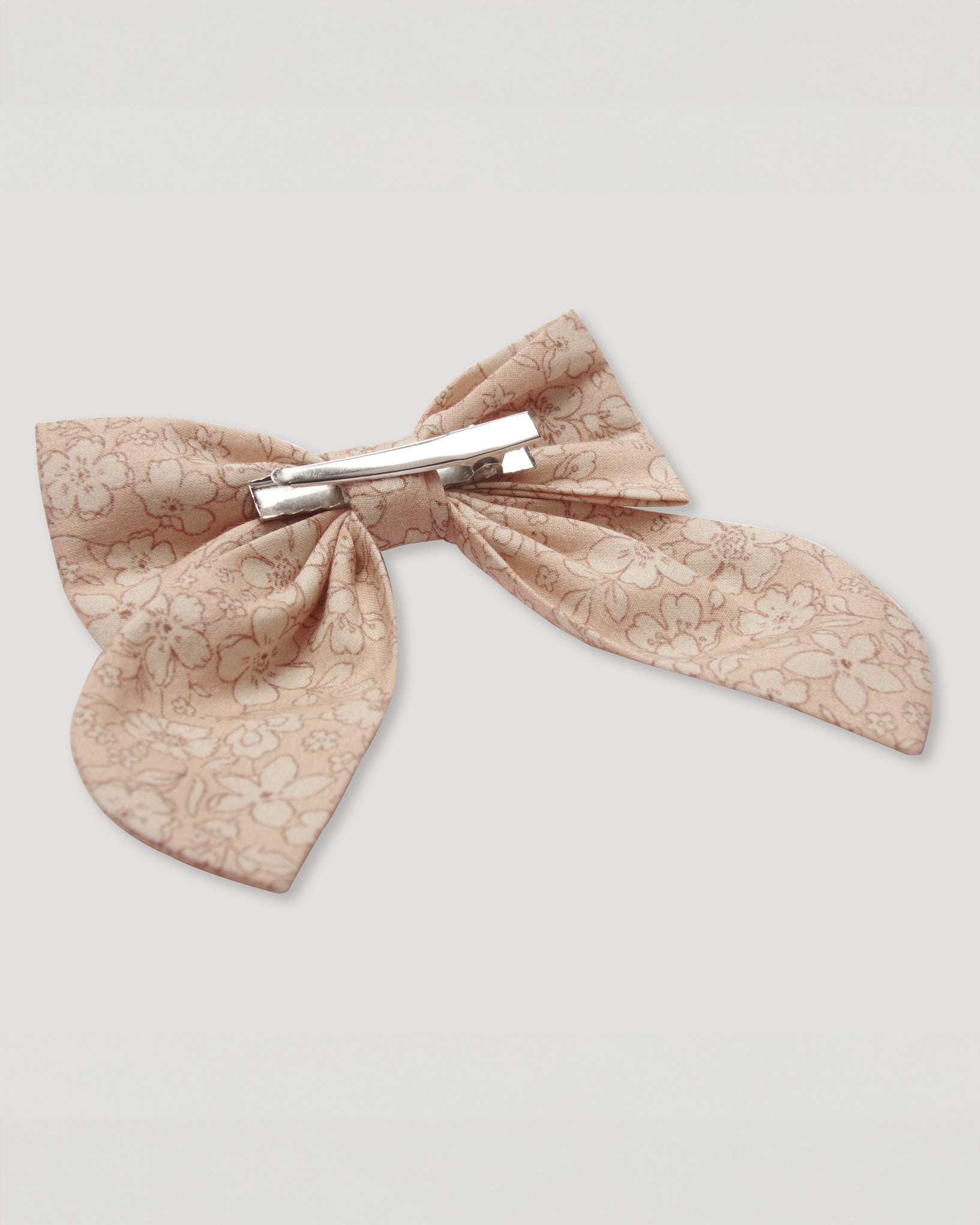 Early Sunday, Audrey Alligator Clip in Garden Flowers print, made from Printed Cotton Cambric fabric, featuring a fabric bow design with a secure hair clip fastening, shown in a closeup flat-lay view