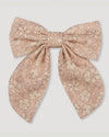 Early Sunday, Audrey Alligator Clip in Garden Flowers print, made from Printed Cotton Cambric fabric, featuring a fabric bow design with a secure hair clip fastening, shown in a front flat-lay view
