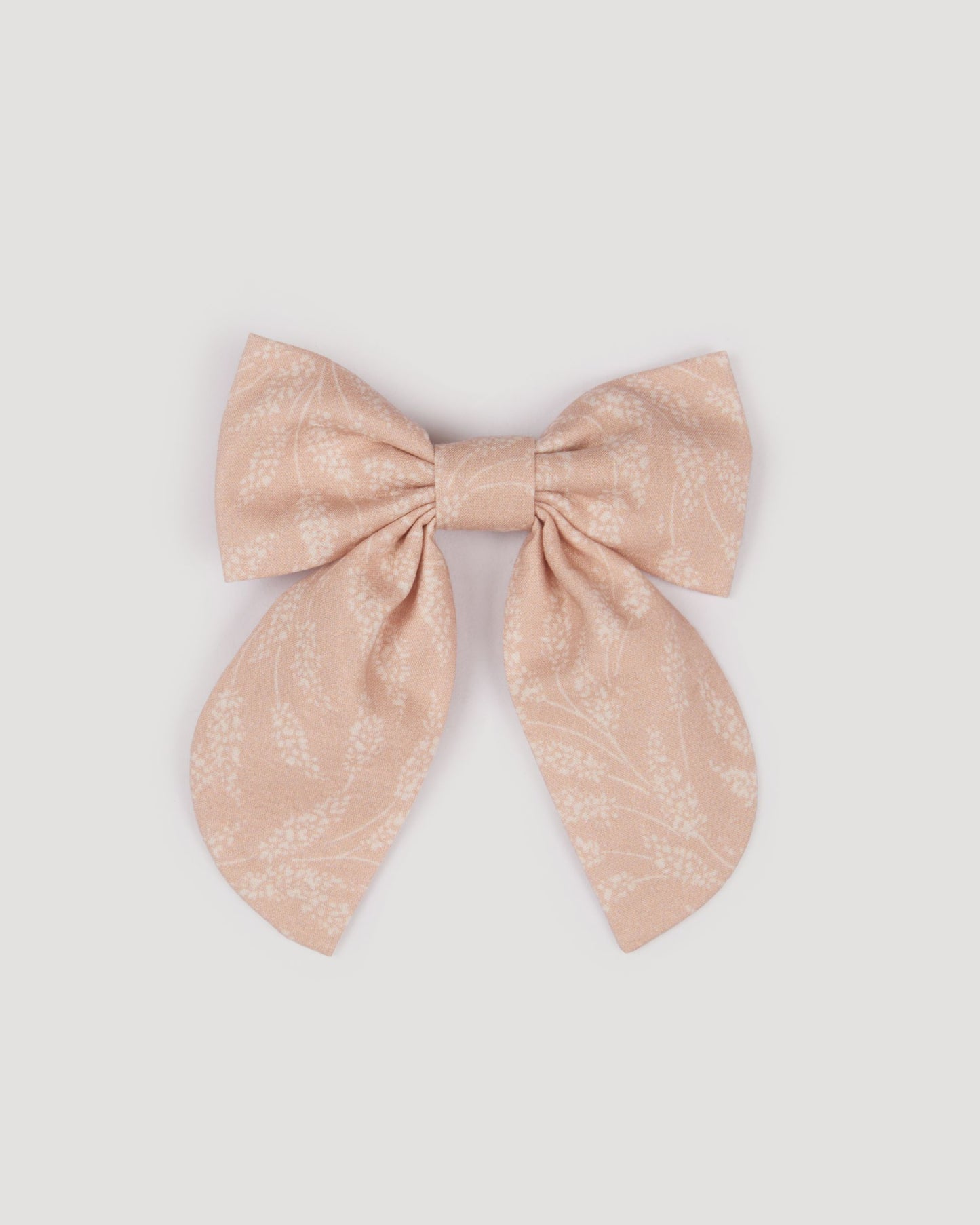 Early Sunday, Audrey Clip in Feather print, made from Printed 60s Cotton Cambric fabric, featuring a fabric bow design with a secure hair clip fastening, shown in a front flat-lay view