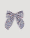 Early Sunday, Audrey Clip in Celestial print, made from Printed 60s Cotton Satin fabric, featuring a fabric bow design with a secure hair clip fastening, shown in a front flat-lay view