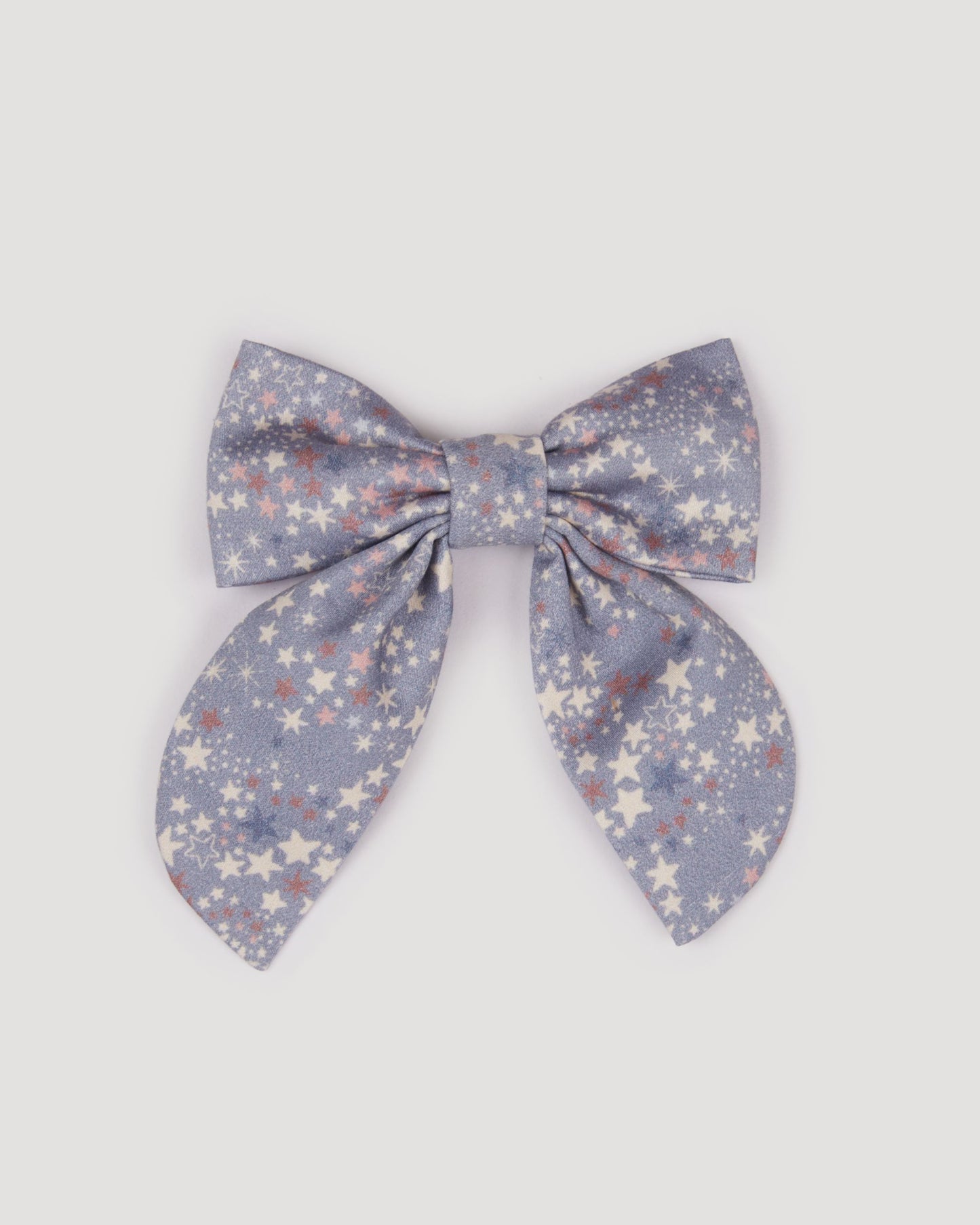 Early Sunday, Audrey Clip in Celestial print, made from Printed 60s Cotton Satin fabric, featuring a fabric bow design with a secure hair clip fastening, shown in a front flat-lay view