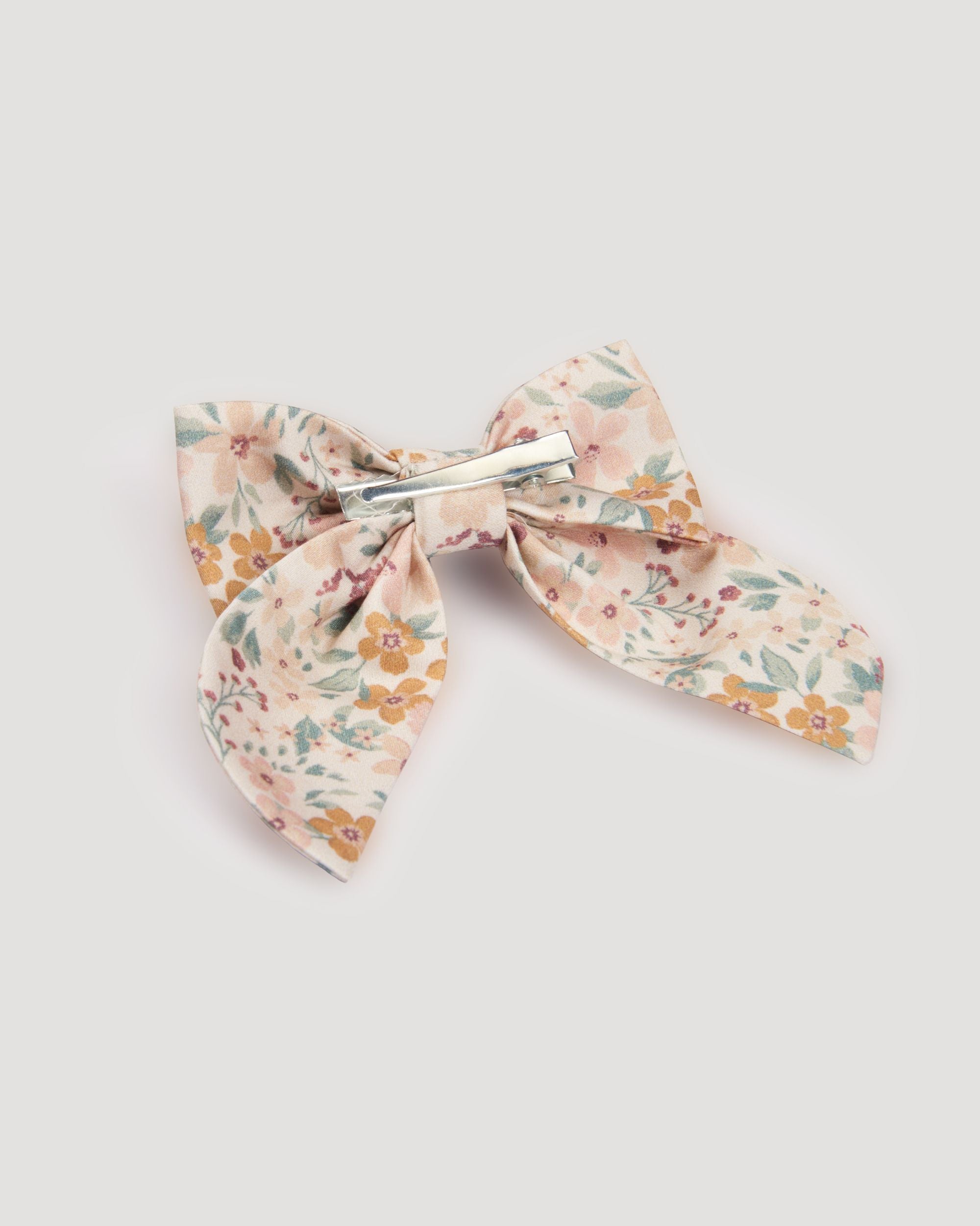 Early Sunday, Audrey Clip in Floral print, made from Printed 60s Cotton Satin fabric, featuring a fabric bow design with a secure hair clip fastening, shown in a back flat-lay view
