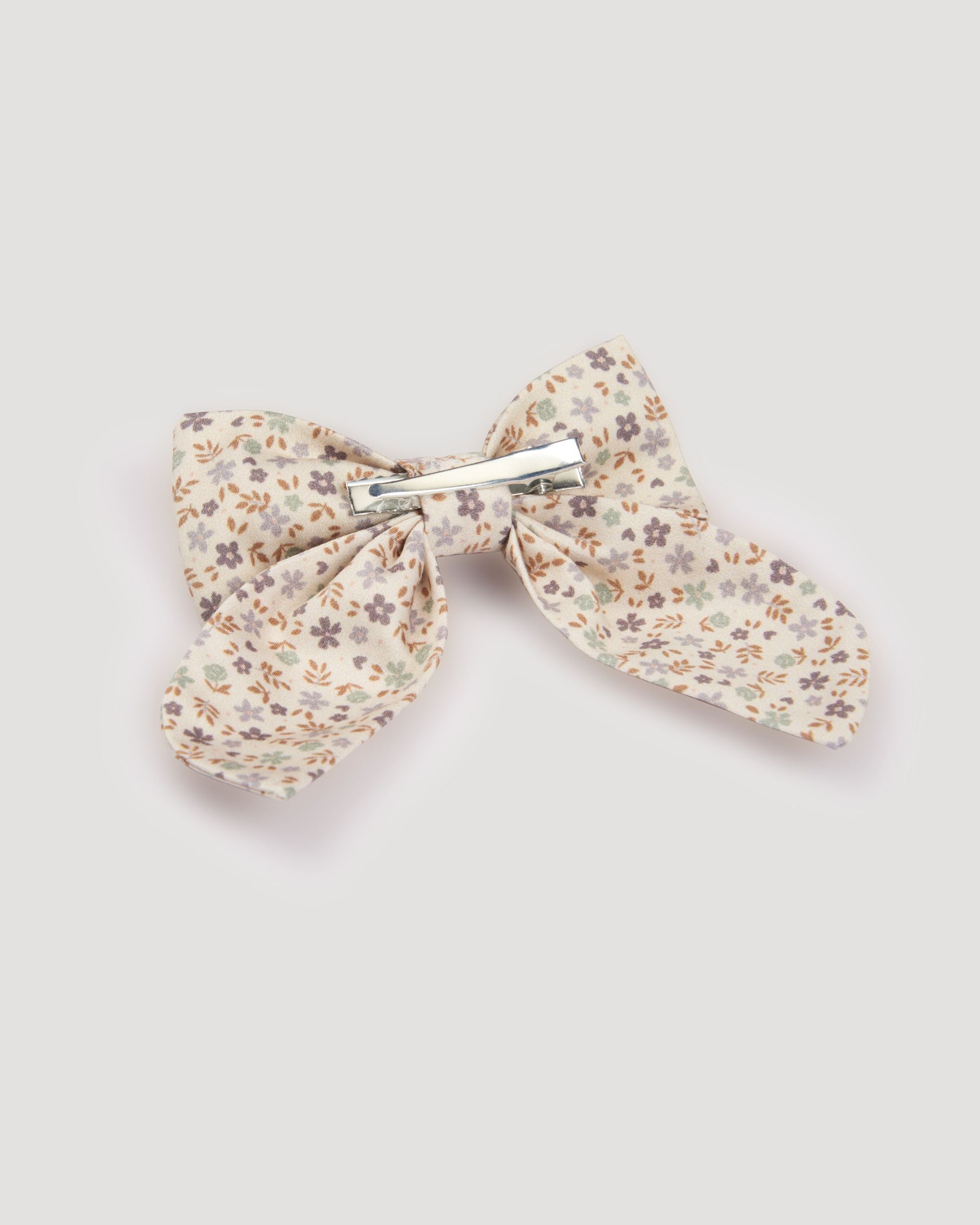Early Sunday, Audrey Clip in Mini Flowers print, made from Printed 60s Cotton Satin fabric, featuring a fabric bow design with a secure hair clip fastening, shown in a back flat-lay view