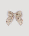 Early Sunday, Audrey Clip in Mini Flowers print, made from Printed 60s Cotton Satin fabric, featuring a fabric bow design with a secure hair clip fastening, shown in a front flat-lay view