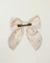 Early Sunday, Audrey Clip in Painted Bouquet print, made from Printed 70% Cotton, 30% Linen fabric, featuring a fabric bow design with a secure hair clip fastening, shown in a back flat-lay view