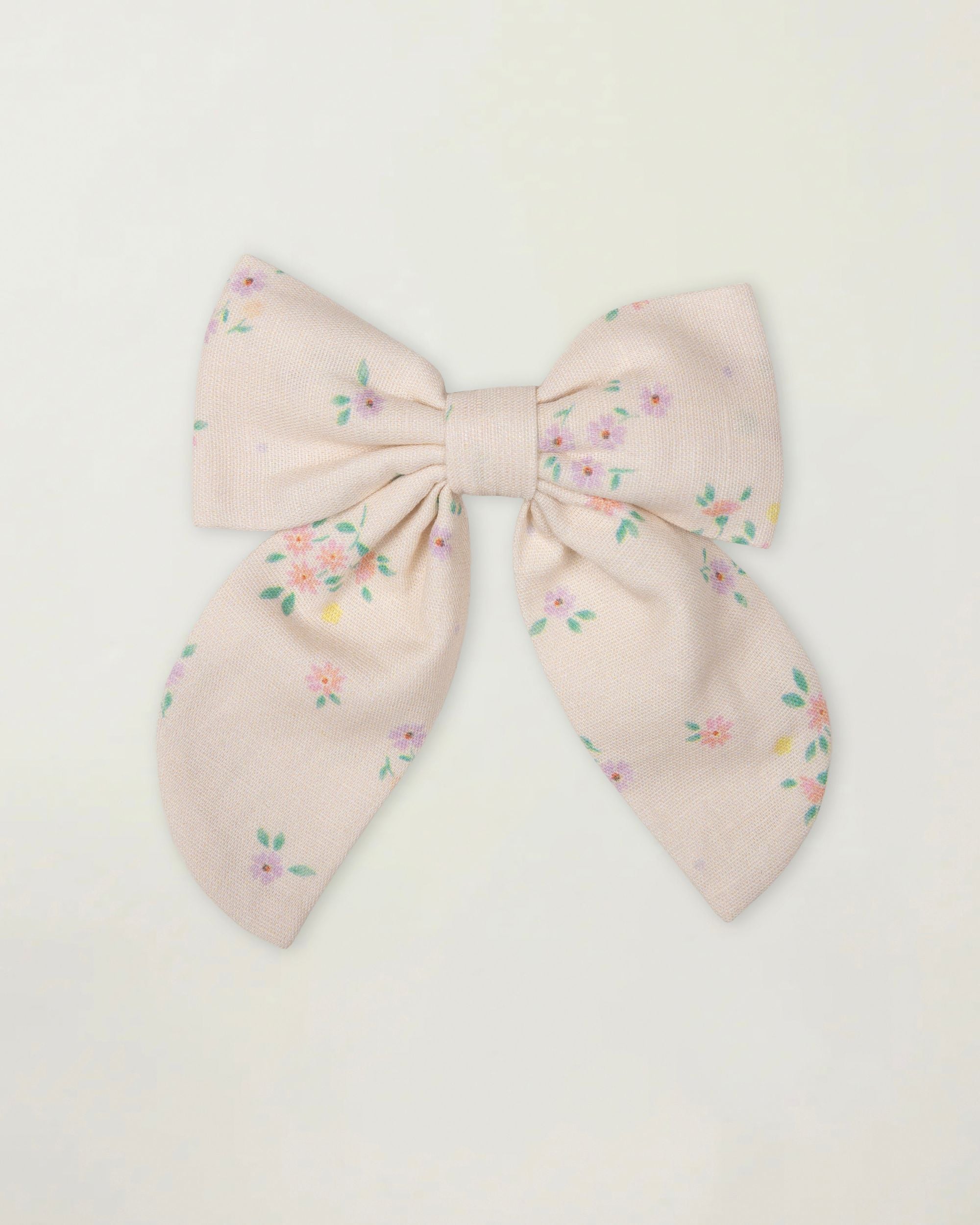 Early Sunday, Audrey Clip in Painted Bouquet print, made from Printed 70% Cotton, 30% Linen fabric, featuring a fabric bow design with a secure hair clip fastening, shown in a front flat-lay view
