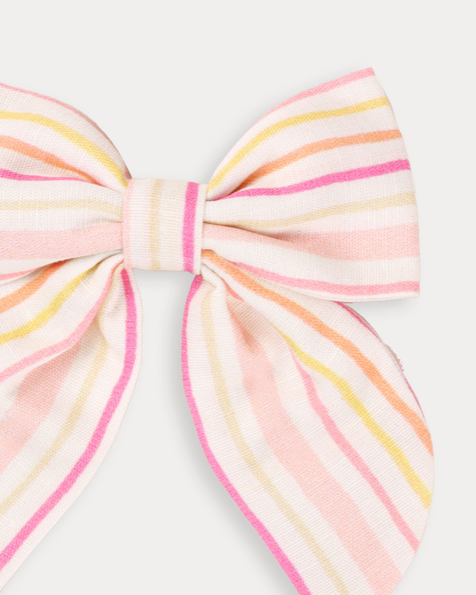 Early Sunday, Audrey Clip in Pink Stripes print, made from Printed 70% Cotton, 30% Linen fabric, featuring a fabric bow design with a secure hair clip fastening, shown in a closeup flat-lay view