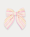 Early Sunday, Audrey Clip in Pink Stripes print, made from Printed 70% Cotton, 30% Linen fabric, featuring a fabric bow design with a secure hair clip fastening, shown in a front flat-lay view