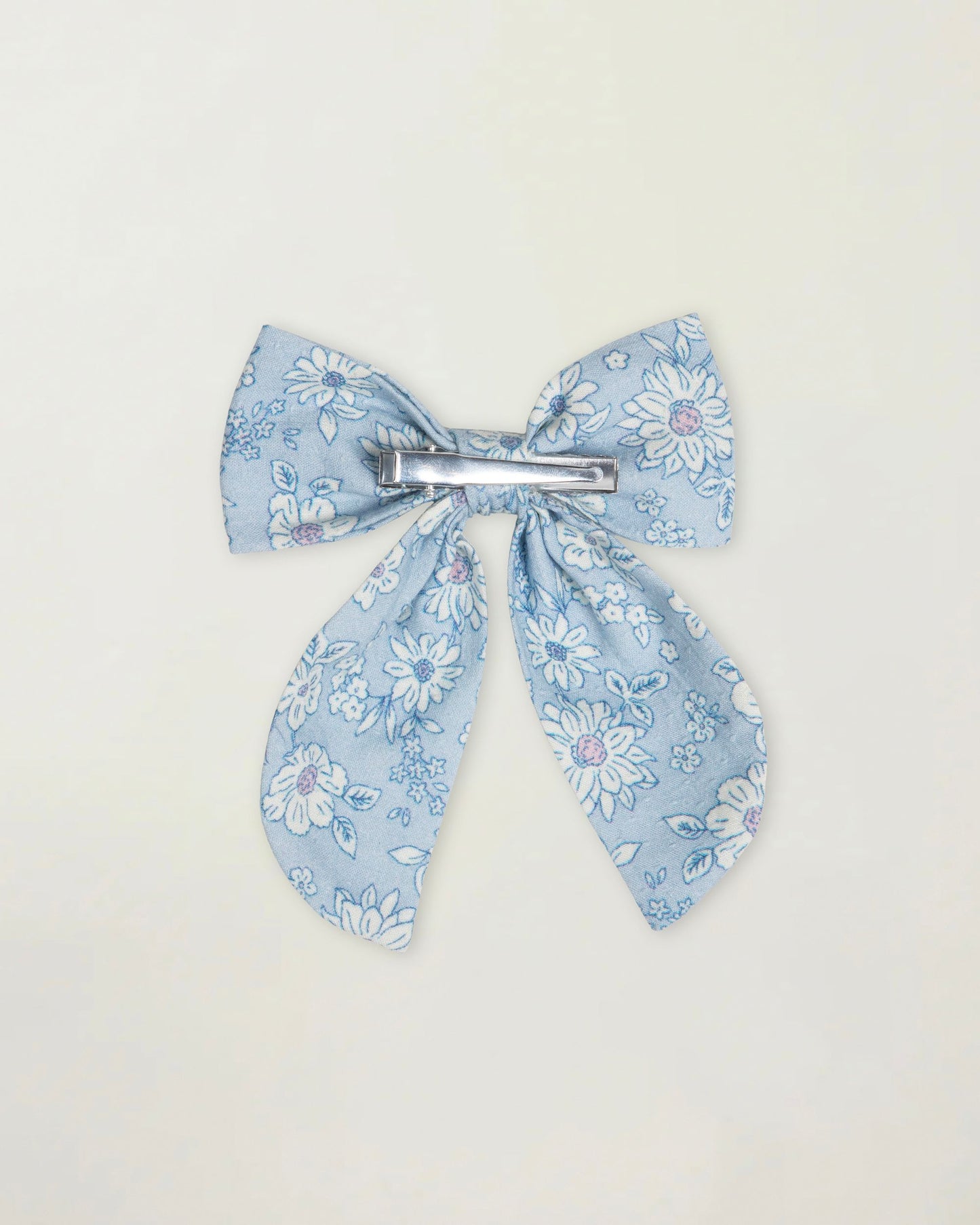 Early Sunday, Audrey Clip in Tonal Floral Blue color, made from Printed 70% Cotton, 30% Linen fabric, featuring a fabric bow design with a secure hair clip fastening, shown in a back flat-lay view