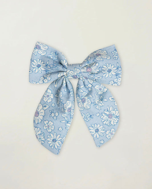 Early Sunday, Audrey Clip in Tonal Floral Blue color, made from Printed 70% Cotton, 30% Linen fabric, featuring a fabric bow design with a secure hair clip fastening, shown in a front flat-lay view