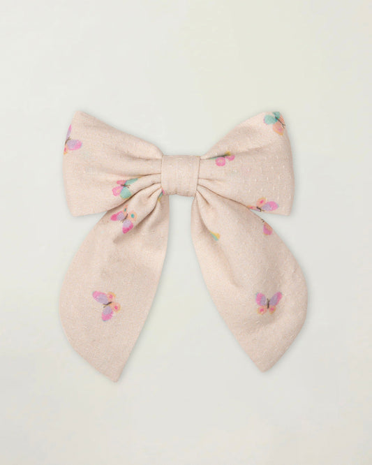 Early Sunday, Audrey Clip in Butterflies print, made from Printed Cotton Tiny Swiss Dobby fabric, featuring a fabric bow design with a secure hair clip fastening, shown in a front flat-lay view