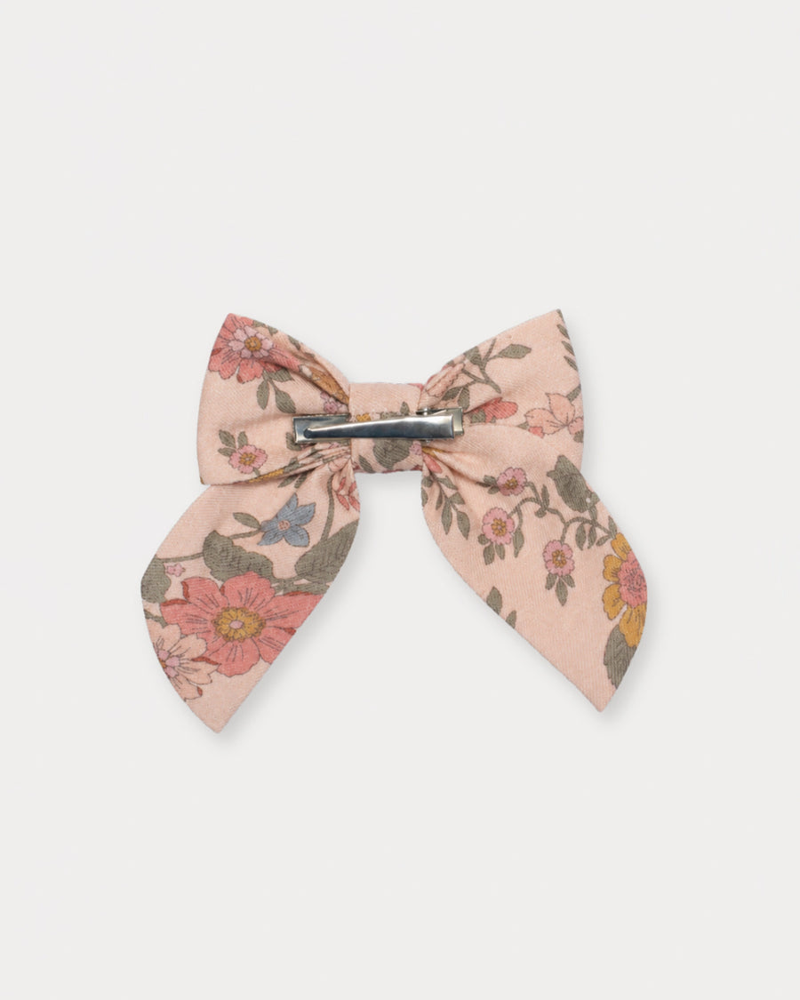 Early Sunday, Audrey Clip in Bloom Blush, made from Printed Viscose Twill fabric, featuring a fabric bow design with a secure hair clip fastening, shown in a back flat-lay view