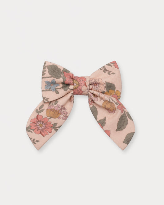 Early Sunday, Audrey Clip in Bloom Blush, made from Printed Viscose Twill fabric, featuring a fabric bow design with a secure hair clip fastening, shown in a front flat-lay view