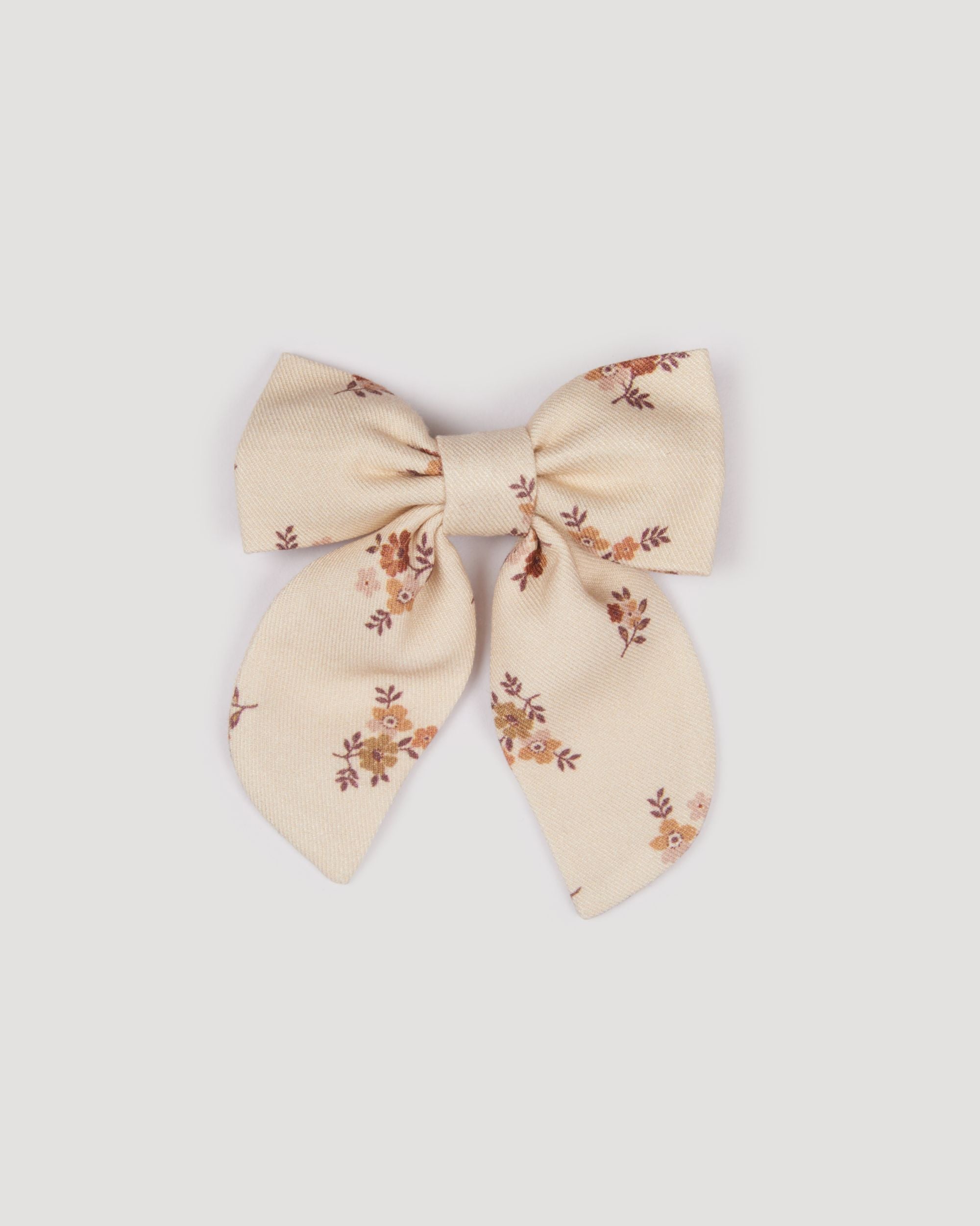 Early Sunday, Audrey Clip in Ditsy Bouquet Cream print, made from Printed Viscose Twill fabric, featuring a fabric bow design with a secure hair clip fastening, shown in a front flat-lay view