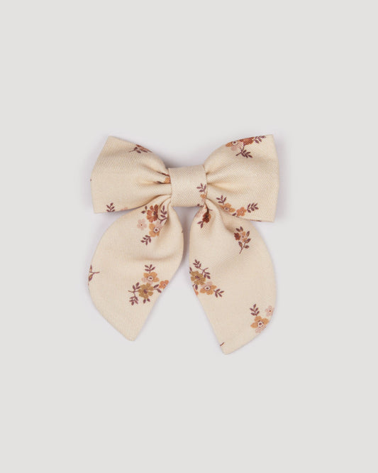 Early Sunday, Audrey Clip in Ditsy Bouquet Cream print, made from Printed Viscose Twill fabric, featuring a fabric bow design with a secure hair clip fastening, shown in a front flat-lay view