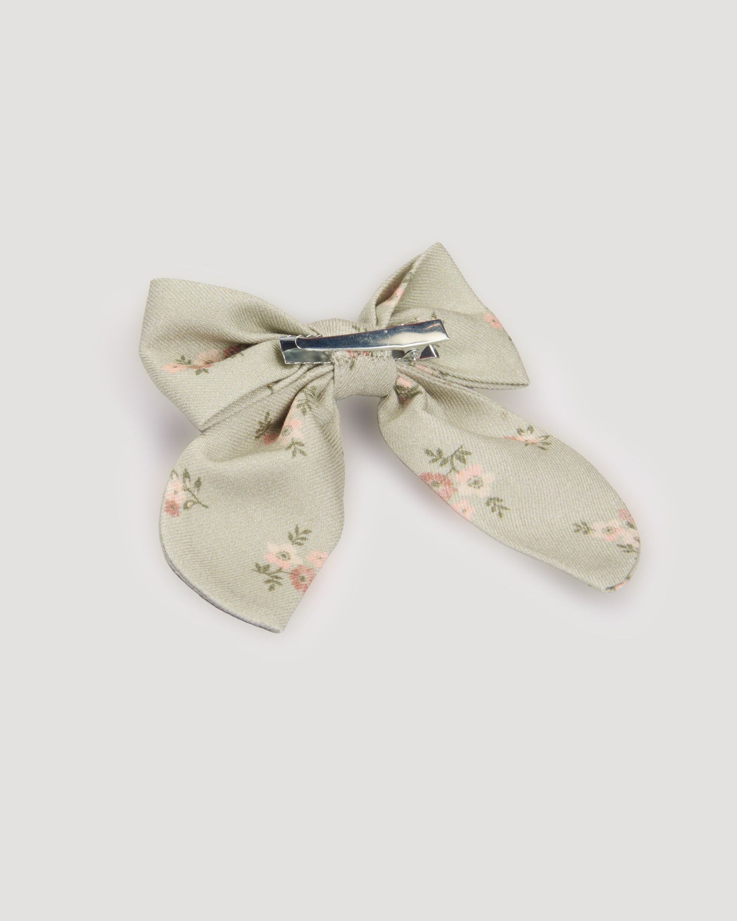 Early Sunday, Audrey Clip in Ditsy Bouquet Jade print, made from Printed Viscose Twill fabric, featuring a fabric bow design with a secure hair clip fastening, shown in a back flat-lay view