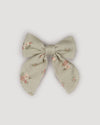 Early Sunday, Audrey Clip in Ditsy Bouquet Jade print, made from Printed Viscose Twill fabric, featuring a fabric bow design with a secure hair clip fastening, shown in a front flat-lay view
