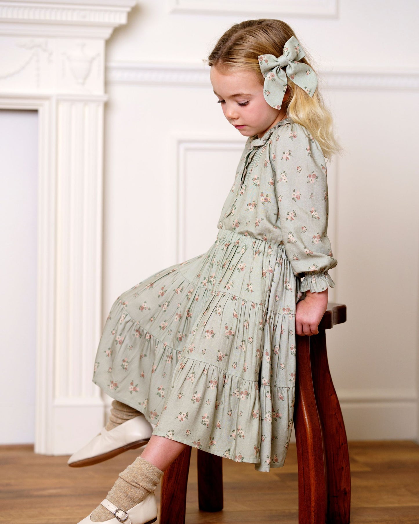 Early Sunday, Audrey Clip in Ditsy Bouquet Jade print, made from Printed Viscose Twill fabric, featuring a fabric bow design with a secure hair clip fastening, shown in a side view of model wearing it