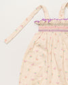 Early Sunday, Audrey Overall Baby Romper in Butterflies print, made from 100% Cotton Swiss Dobby Tiny Dots fabric, featuring tie-up shoulder straps with dot texture & smocked waistband, shown in a closeup flat-lay view