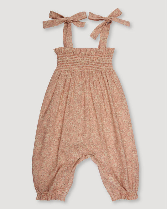 Early Sunday, Audrey Smocked Romper in Garden Flowers print, made from Printed Cotton Cambric fabric, featuring smocked chest and tie up straps, shown in a front flat-lay view