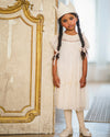 Early Sunday, Aurelia Dress in Hazelnut Cream, made from Dyed Nylon Mesh Dobby fabric, featuring Layered ruffles with flutter sleeves, shown in a front view of model wearing it
