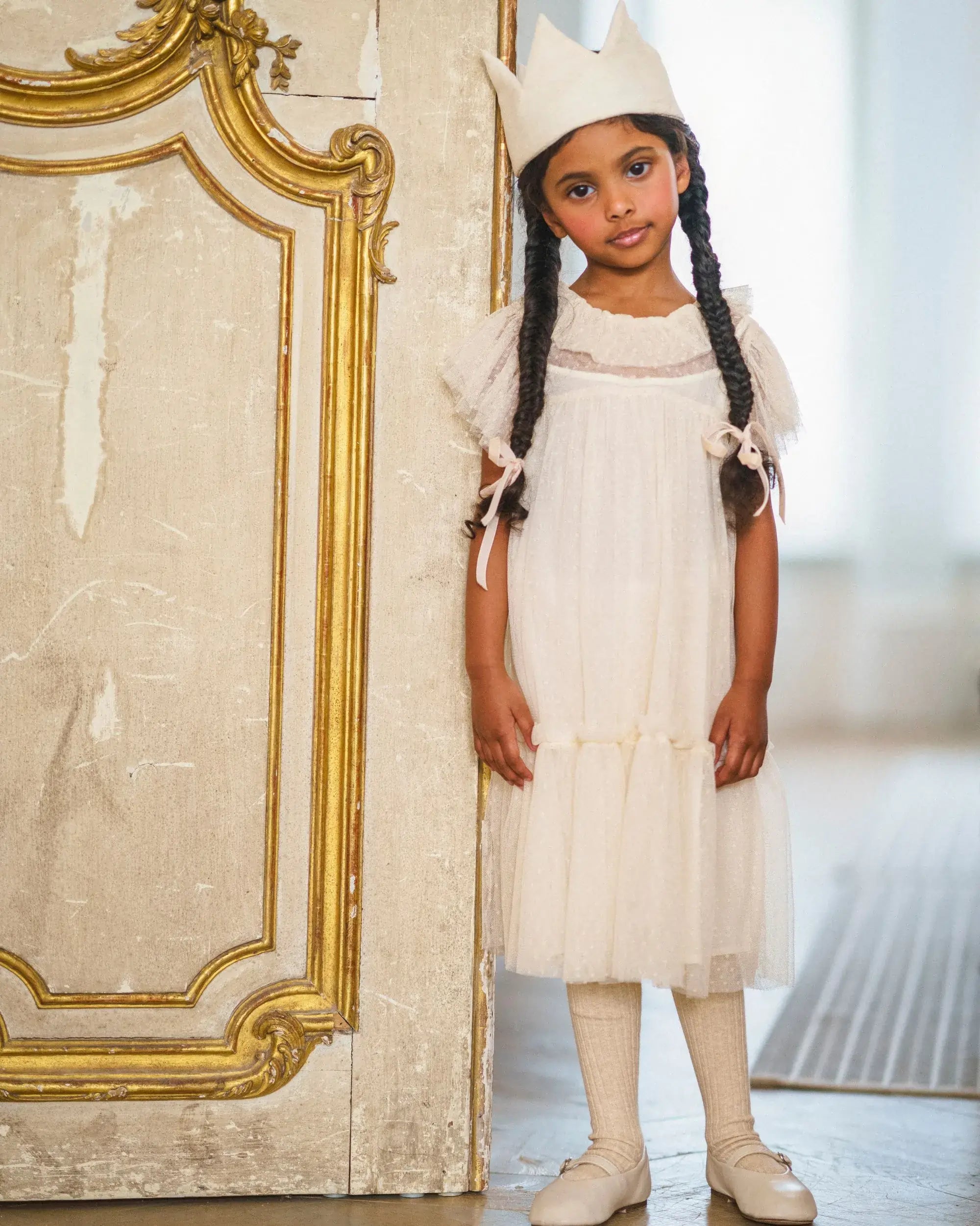 Early Sunday, Aurelia Dress in Hazelnut Cream, made from Dyed Nylon Mesh Dobby fabric, featuring Layered ruffles with flutter sleeves, shown in a front view of model wearing it