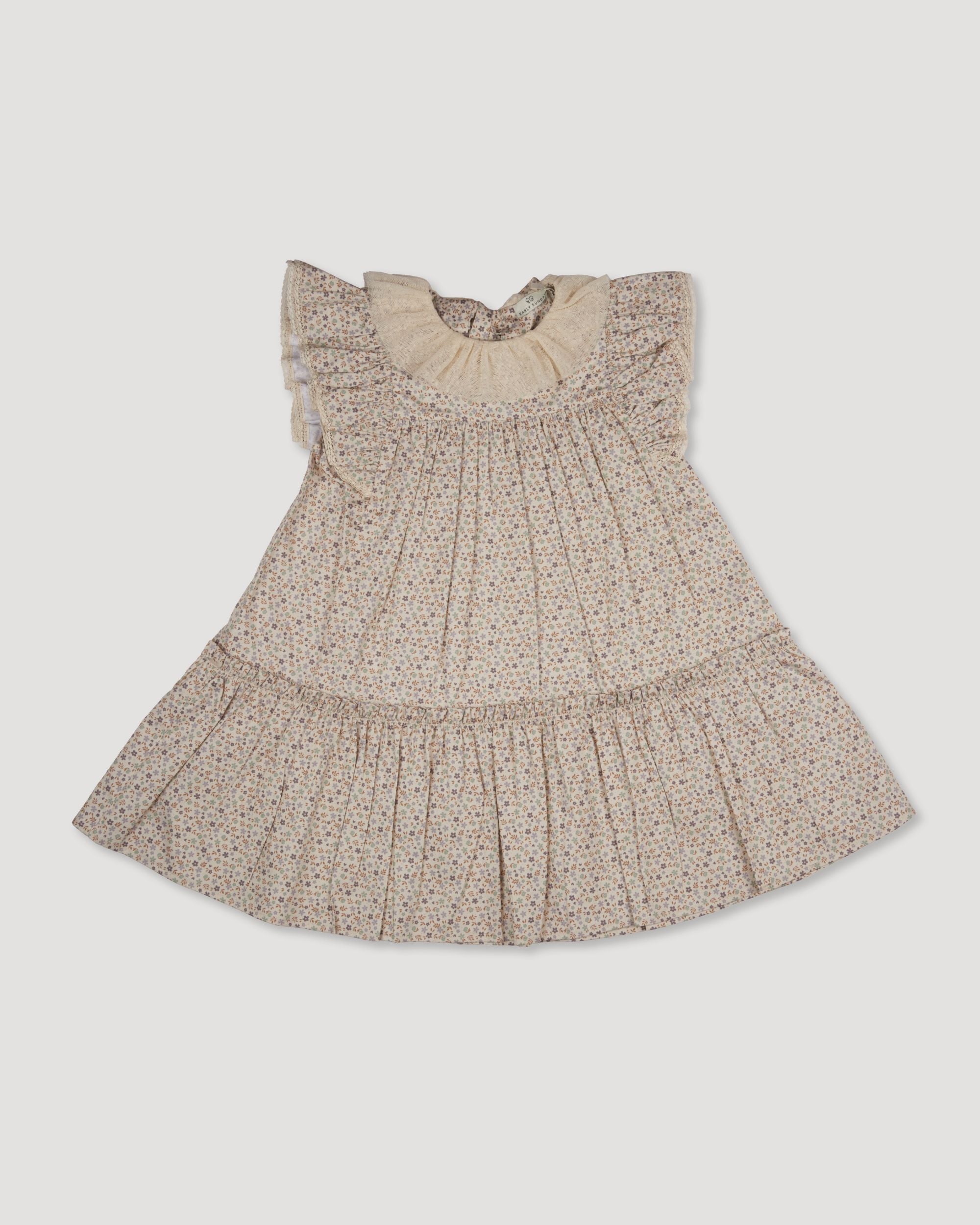 Early Sunday, Aurelia Dress in Miny Flowers print, made from Printed Cotton Satin fabric, featuring Layered ruffles with flutter sleeves, shown in a front flat-lay view