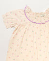 Early Sunday, Baby Bella Dress with Bloomer in Butterflies print, made from 100% Cotton Swiss Dobby Tiny Dots fabric, featuring short puff sleeves with a lilac lace & matching bloomers, shown in a closeup flat-lay view