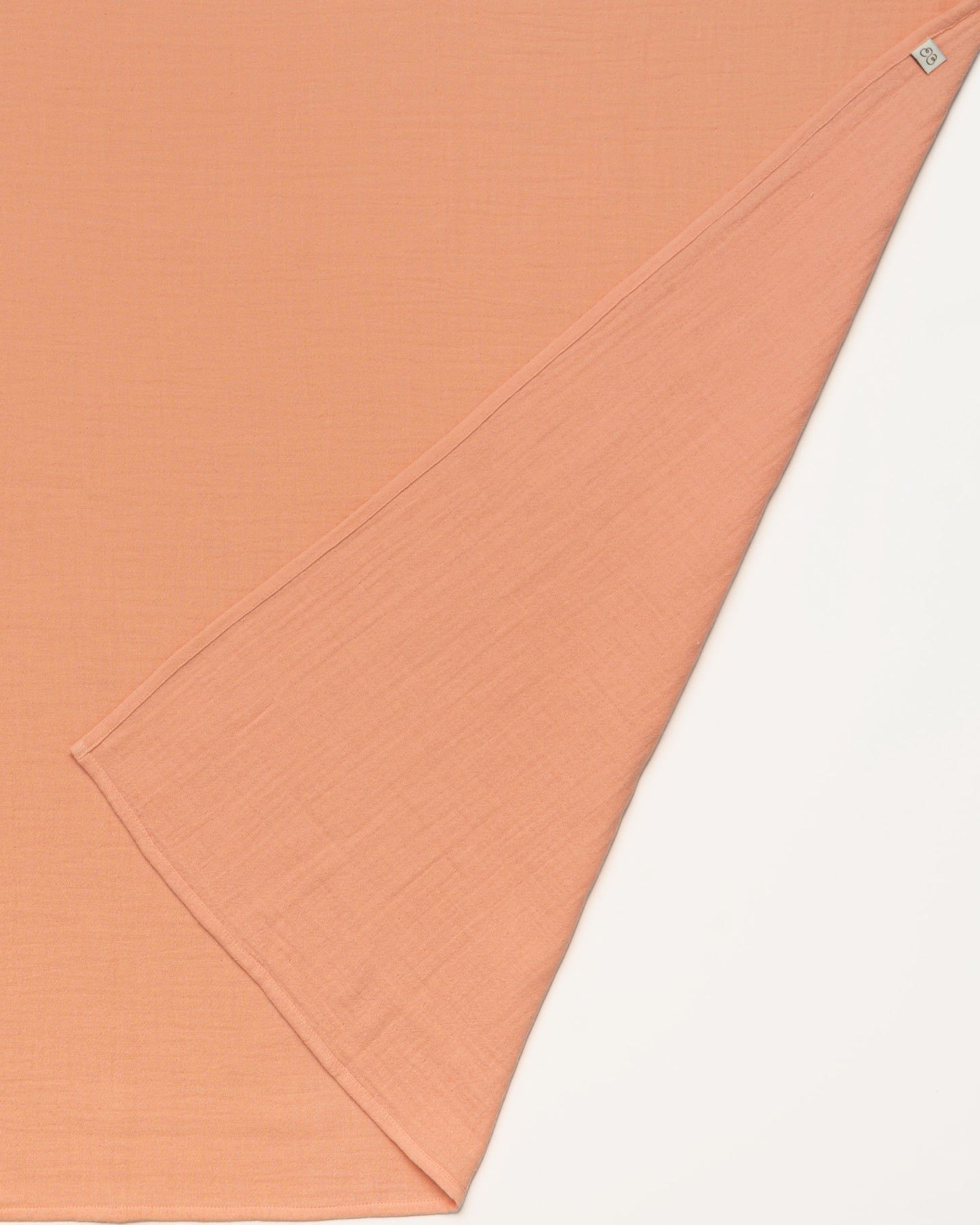 Early Sunday, Baby Napkin in Candy Floss color, made from Printed Cotton Double Gauze fabric, shown in a closeup flat-lay view