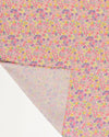 Early Sunday, Baby Napkin in Emma Floral Purple color, made from Printed Cotton Double Gauze fabric, shown in a closeup flat-lay view