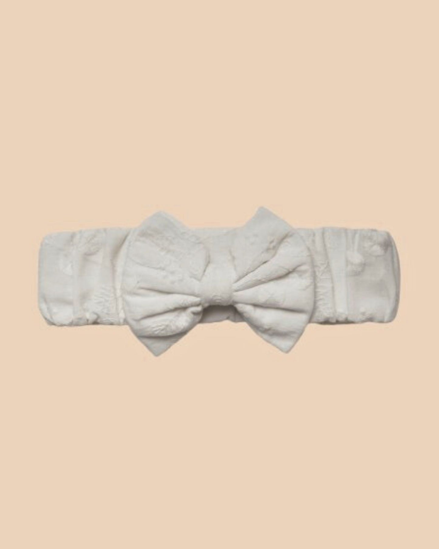 Early Sunday, Baby's Bow Headband in Ivory color, made from All-Over Embroidered Fabric fabric, featuring a wide bow design, shown in a front flat-lay view