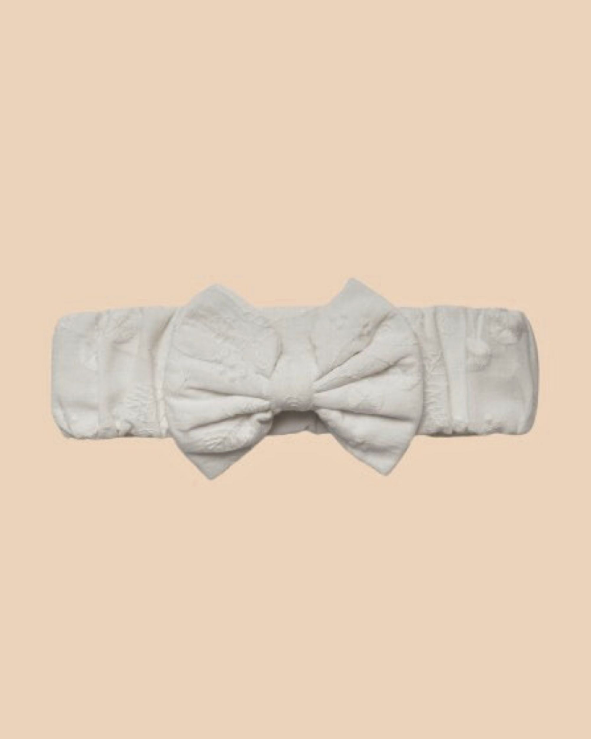 Early Sunday, Baby's Bow Headband in Ivory color, made from All-Over Embroidered Fabric fabric, featuring a wide bow design, shown in a front flat-lay view