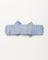 Early Sunday, Baby's Bow Headband in Summer Sky color, made from Chambray fabric, featuring a wide bow design, shown in a back flat-lay view