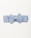 Early Sunday, Baby's Bow Headband in Summer Sky color, made from Chambray fabric, featuring a wide bow design, shown in a front flat-lay view