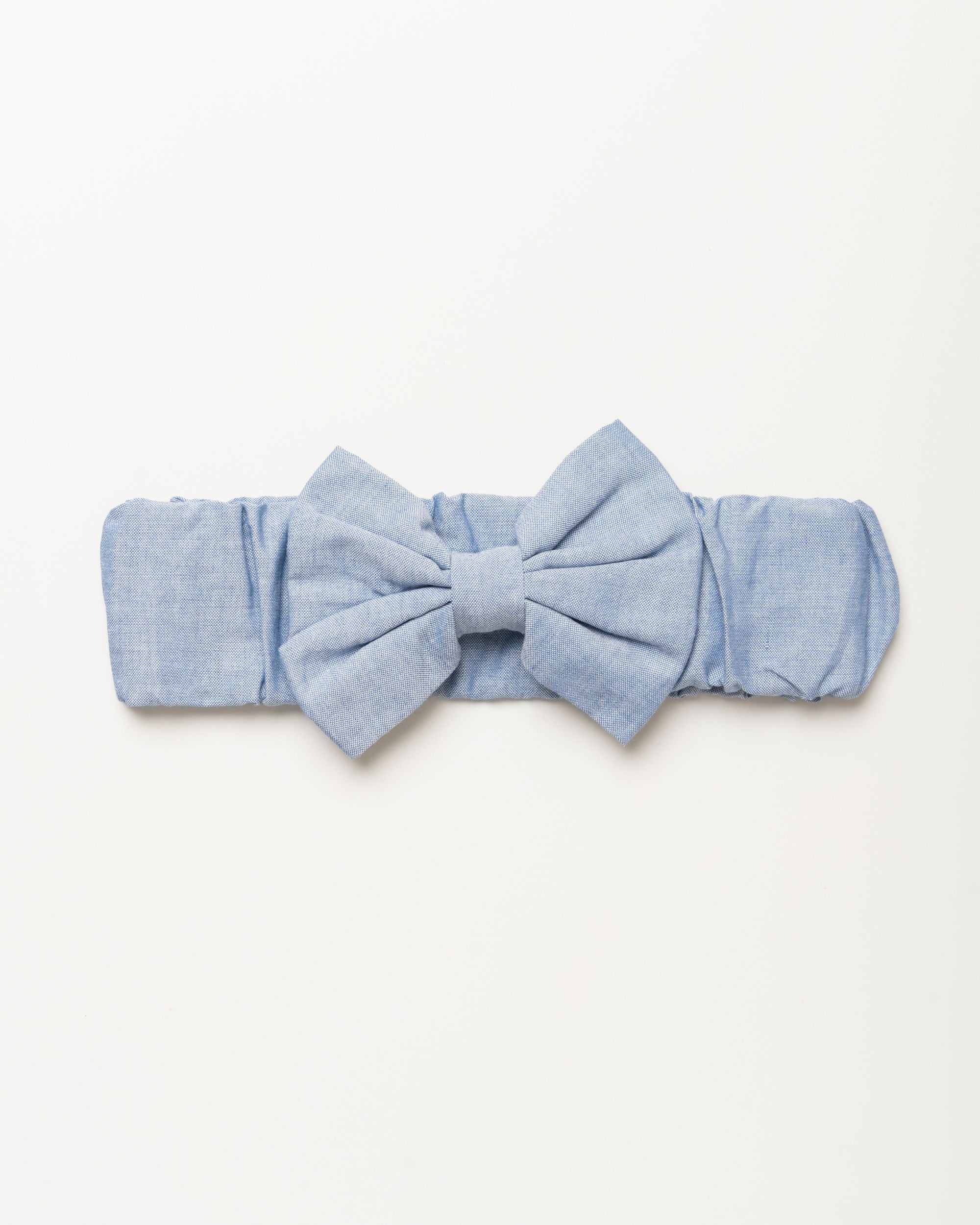 Early Sunday, Baby's Bow Headband in Summer Sky color, made from Chambray fabric, featuring a wide bow design, shown in a front flat-lay view