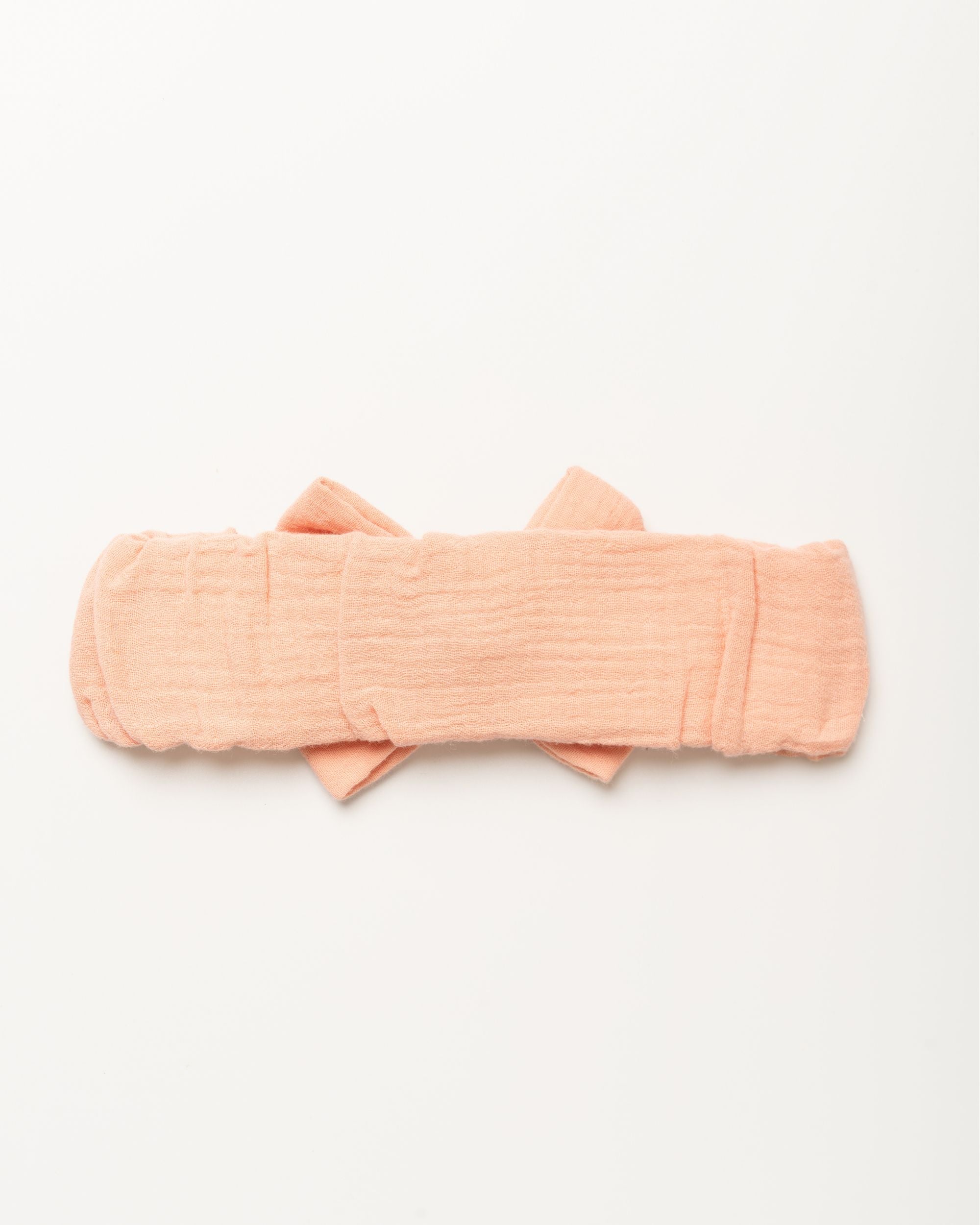 Early Sunday, Baby's Bow Headband in Candy Floss color, made from Cotton Double Gauze fabric, featuring a wide bow design, shown in a back flat-lay view