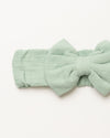 Early Sunday, Baby's Bow Headband in Mint color, made from Cotton Double Gauze fabric, featuring a wide bow design, shown in a closeup flat-lay view
