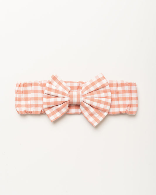 Early Sunday, Baby's Bow Headband in Peony color, made from Gingham Check fabric, featuring a wide bow design, shown in a front flat-lay view