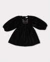 Early Sunday, Belle Dress in Black, made from Cotton Velvet Velour's fabric, featuring a flowing silhouette with puff sleeves and gentle gathers, shown in a front flat-lay view